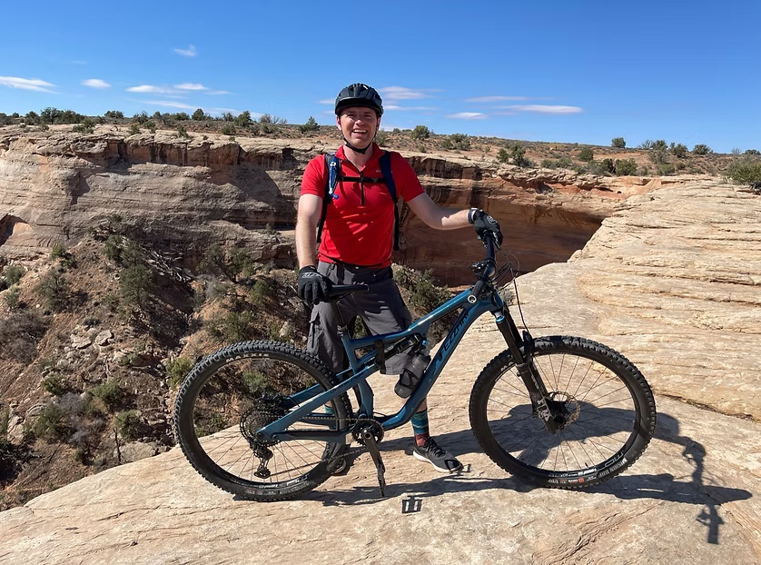 Tim Gubler with his mountain bike on a rocky trail